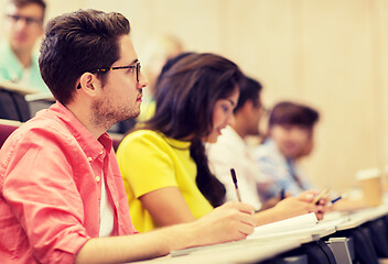 Image showing group of students with notebooks in lecture hall