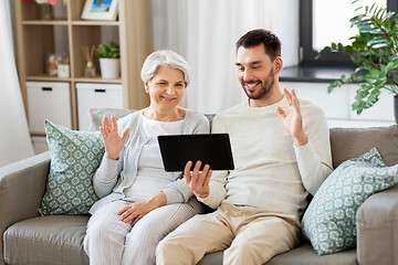 Image showing old mother and adult son with tablet pc at home