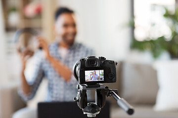 Image showing camera recording video blogger with headphones