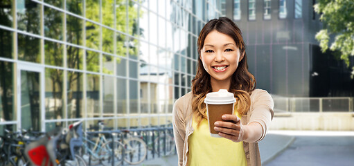 Image showing happy asian woman with coffee on city street