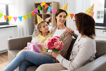 Image showing grandmother greeting mother on birthday at home