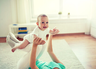 Image showing happy mother playing with baby at home