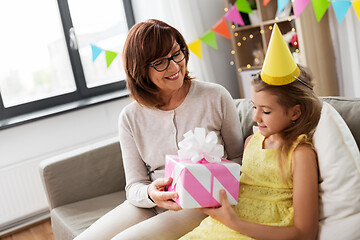 Image showing grandmother giving granddaughter birthday gift