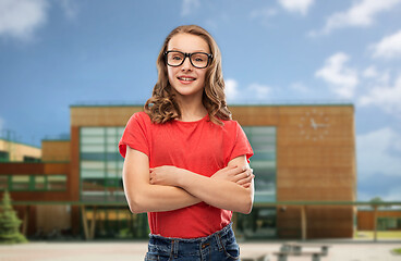 Image showing smiling student girl in glasses over school