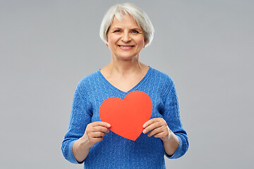 Image showing smiling senior woman with red heart