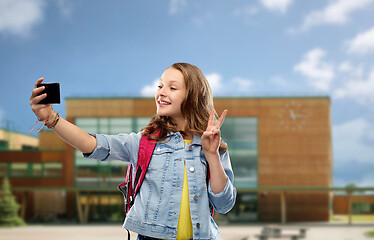 Image showing girl taking selfie by smartphone over school