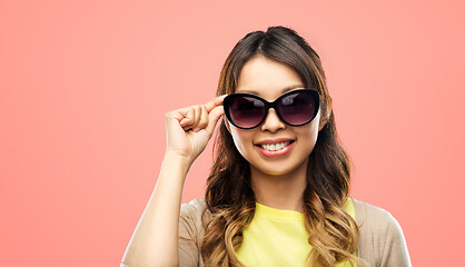 Image showing happy smiling young asian woman in sunglasses