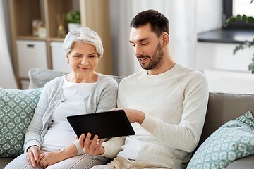 Image showing old mother and adult son with tablet pc at home