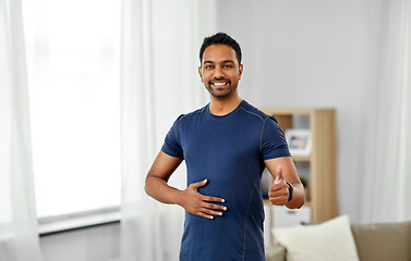 Image showing indian man with fitness tracker showing thumbs up