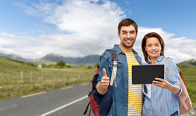 Image showing happy couple of tourists with tablet computer