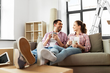 Image showing happy couple drinking coffee moving to new home