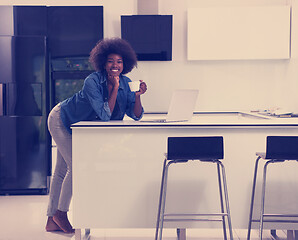 Image showing smiling black woman in modern kitchen