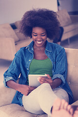 Image showing african american woman at home with digital tablet