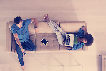 Image showing multiethnic couple relaxes in the living room top view