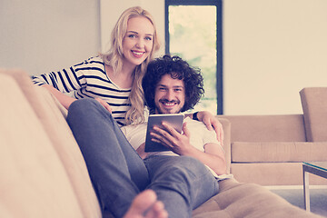 Image showing couple relaxing at  home with tablet computers