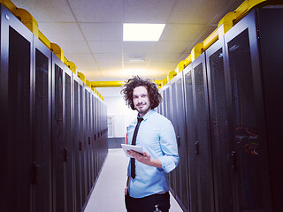 Image showing IT engineer working on a tablet computer in server room