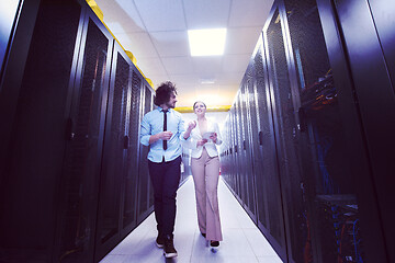 Image showing engineer showing working data center server room to female chief