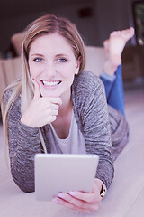 Image showing young women used tablet computer on the floor