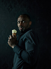 Image showing Portrait of afro american man holding ice cream