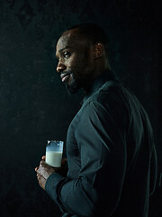 Image showing Healthy young african man holging milk