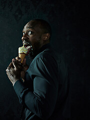 Image showing Portrait of afro american man holding ice cream