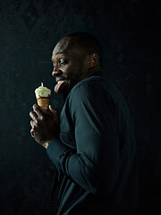 Image showing Portrait of afro american man holding ice cream