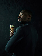 Image showing Portrait of afro american man holding ice cream