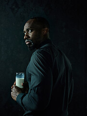 Image showing Healthy young african man holging milk