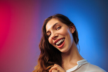 Image showing The happy woman standing and smiling against colored background.