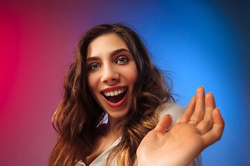 Image showing The happy woman standing and smiling against colored background.