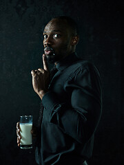 Image showing Healthy young african man holging milk