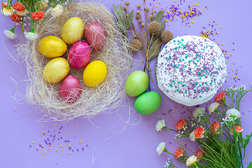 Image showing composition of Easter eggs and cake on a purple background