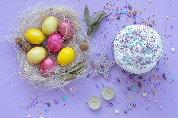 Image showing beautiful beautiful Easter composition in purple tones with painted eggs and cake