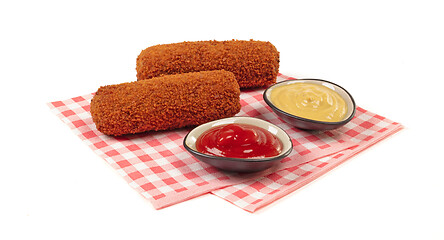 Image showing Brown crusty dutch kroket with sauces (mustard and ketchup) isol