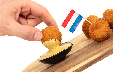 Image showing Dutch traditional snack bitterbal in a hand