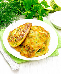 Image showing Pancakes of zucchini on light wooden board