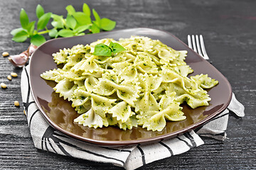 Image showing Farfalle with pesto in plate on dark board
