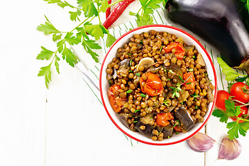 Image showing Lentils with eggplant in bowl on board top