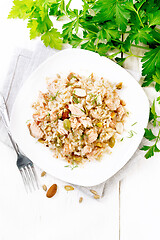 Image showing Salad of salmon and rice in plate on light board top