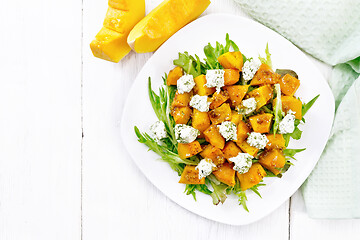 Image showing Salad of pumpkin and cheese in plate on board top