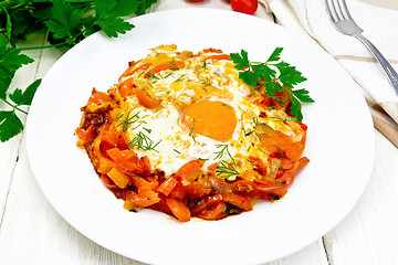 Image showing Scrambled eggs with vegetables in plate on board