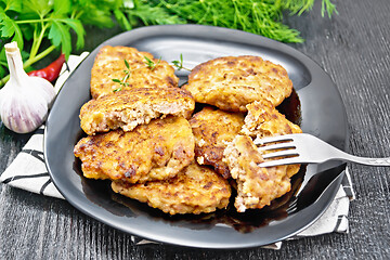 Image showing Fritters meat in black plate on wooden board