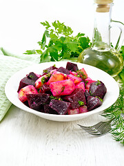 Image showing Salad of beets and potatoes in plate on board