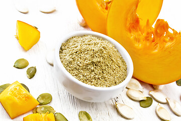 Image showing Flour pumpkin in white bowl on light board