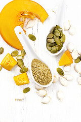 Image showing Flour and seeds pumpkin in spoons on light board top