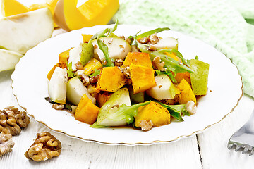 Image showing Salad of pumpkin and pear in plate on board