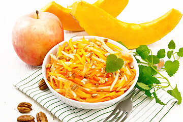 Image showing Salad of pumpkin and apple in bowl on board