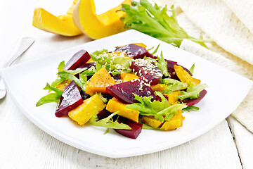 Image showing Salad of pumpkin and beetroot in plate on light board