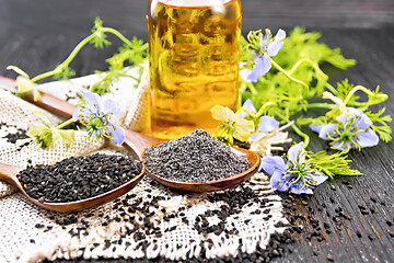 Image showing Flour and seeds of kalingi in spoons on old wooden board