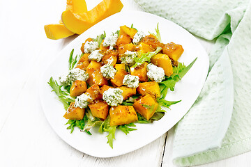 Image showing Salad of pumpkin and cheese in plate on light board